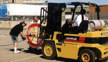 EPS crew using fork lift to coil phone cable