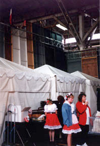 Behind the mercado set, showing booths and dressing area for adjacent stage